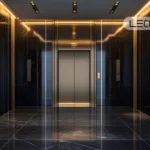 Hotel-style elevator lobby with three dark marble walls, gold lighting, and centered silver elevator doors.