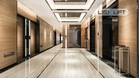 Luxurious hotel hallway with wood-paneled walls, multiple elevator doors along each side, and a marble floor.